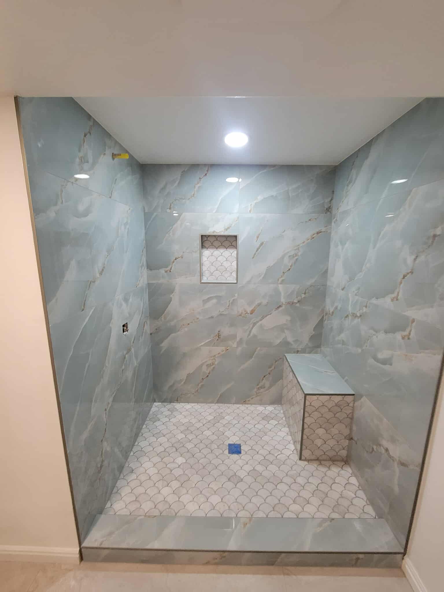 Blue marble tile shower from another angle